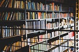 A bookcase filled with books covering an entire wall.