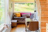 View from a tiny home looking out over a grassy field.