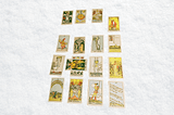 Background: White blanket Foreground: Seventeen Rider Waite tarot cards. Image by Gem Blackthorn