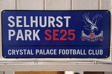 A sign that reads “Selhurts Park SE25” and in smaller print “Crystal Palace Football Club.”