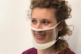 Lady wearing ClearMask, a mask which allows Deaf people to see the persons mouth.