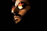 Picture of Ringo Starr wearing glasses in dark lighting