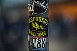 A sticker reading ‘refugees welcome’