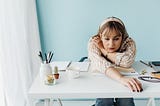 woman sitting at white table