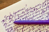 writing in purple ink with a purple pen across the page