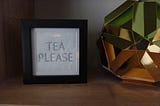 A tea please sign in a frame, unlit