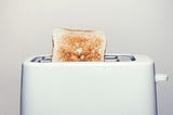 Picture of a toaster with toast sticking out