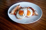 Fried eggs and leftover pizza