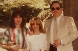An family photo of parents and young teen daughter