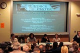 Four panelists at an Ethics Center event title “Religious Diversity at Fresno State. Slide reads, “sponsored by the Ethics Center at Fresno State; co-sponsored by the Philosophy Club, Jewish Studies Association, the Philosophy Department, and the Newman Center.”