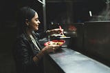 A lovely local woman in a black leather jacket dines on tacos in Mexico. Viva la tacos!