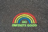 Design painted on concrete of a rainbow over the words Do Infinite Good.