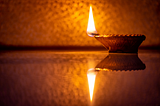 Oil lamp burning on table in dark room