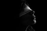 blindfolded woman in the dark