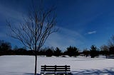 An empty bench looking into a lonely landscape