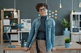 A lady in the office, posing for the camera.