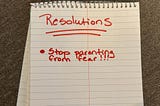 Notebook paper with the word “Resolutions” written in red and underneath a red dot with the words “Stop parenting from fear” next to it