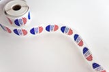 A scroll of stickers that say “I voted”