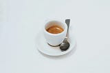 A cup of espresso against a white background.