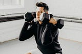 An athlete working out while wearing the Tech Hoodie, a great addition to an authentic personal style.