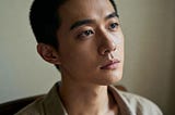 A person in quiet contemplation, their face showing both vulnerability and deep understanding as they experience the moment of truly seeing themselves without resistance or judgment, experiencing raw honest self-recognition.