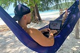 Me working from my computer in a hammock on the beach