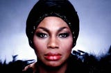 Color photo of Leontyne Price wearing a black turban.
