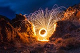 spiral firework in mountains by Wil Stewart