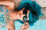 Blue haired girl wearing sunglasses