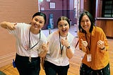 3 women standing together smiling and giving a thumbs up (Linda Trieu, Miranda Mitropoulos and Kym Cooper)