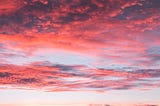 red blue and orange streaks cover the sky during a vivid sunset