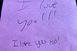 A pink post-it with the words “I love you” and “I love you too!”