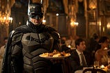 Batman acting as a waiter in a restaurant