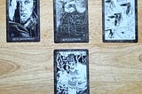 A four-card tarot spread in shades of black and white.