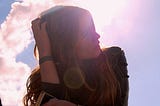 woman-dark-jacket-sky-looking-up