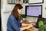 A woman auditing her designs on her computer.