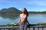 A woman stands in front of a waterway