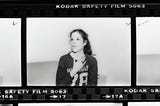 Film strip of Gilda Radner gesturing with her hands and smiling