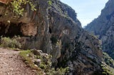 Me hiking on Ruta del Cares with a cave in the background