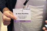 A picture of me holding a name badge that says ‘Dr Pete Nuckley’
