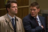 A screen-grab of Supernatural, wherein Dean on the right of the image looks at Castiel, on the left