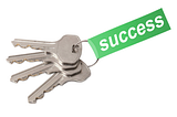 A picture of four keys on a keyring with a tag attached that says “success” on it.