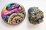 Crazy Aaron’s Thinking Putty in color Social Butterfly with yellow, blue, green, and orange glitter