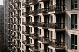Repeating balconies on a modern apartment building with soft, even light.
