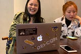 Image showing a reporter with a Defcon Sticker at the China 1.0 press conference.