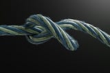 Slack rope with a loosened knot, symbolizing reduced strain and systems returning to cooperation