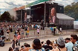 The band Men I Trust performing at Osheaga under a cloudy sky.