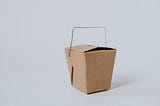 Brown takeout box with wire handle