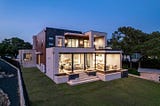 Zbranek_Holt_LakeLBJ_Modern_Luxury_Lakehouse_Elevated_View_Glass_Walls_Terrace_Seating