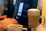 Programmer hands on yhe pc and a cup of coffee with the text love.